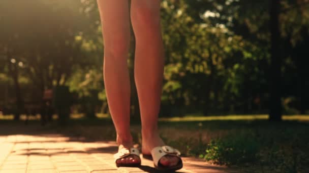 B roll legs woman walks in park — Stock Video