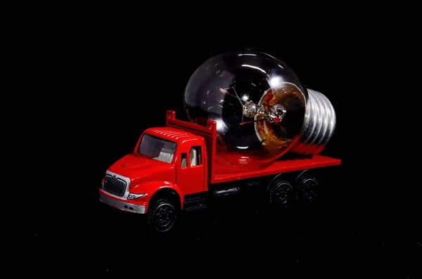 Concepto Energía Eléctrica Camión Rojo Bombilla Sobre Fondo Negro — Foto de Stock