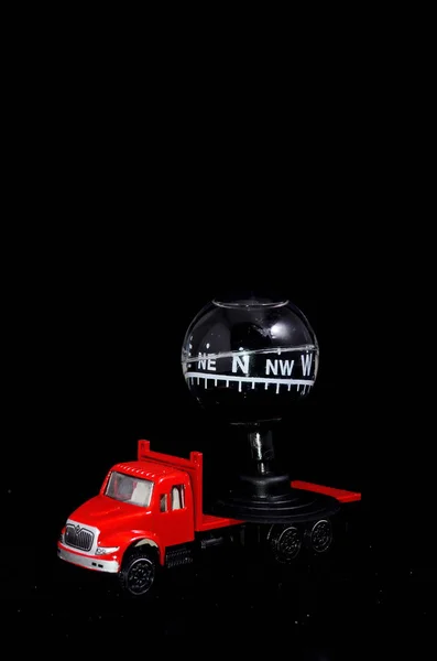 Orientation Transportation Concept Compass Red Toy Truck Black Background — Stock Photo, Image