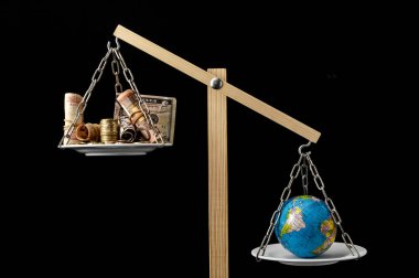 Globe Planet Earth and Money on a Two Pan Balance clipart