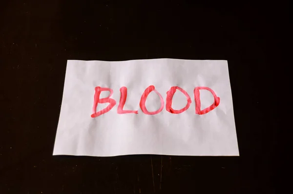 Word Blood Text Auf Einem Weißbuch Geschrieben — Stockfoto