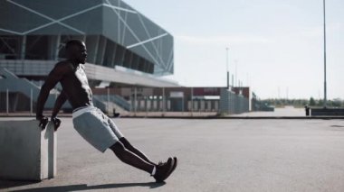 Sokak egzersiz. Şınav ve açık havada spin egzersiz yapan atletik Afro-Amerikan erkek. Bir zenci spor stadium yanında oynuyor. Egzersiz, fitness, motivasyon, çalışan