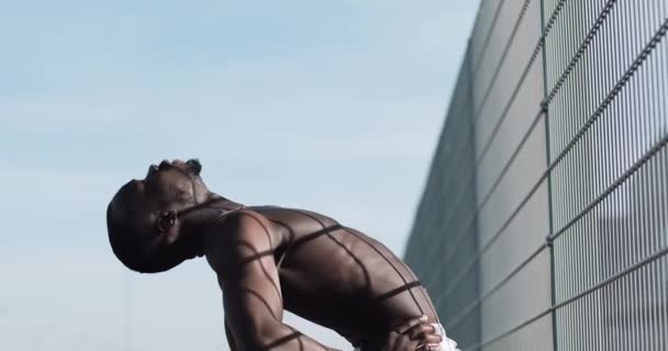 African American athlet mężczyzna robi rano ćwiczenia na zewnątrz Zamknij się powolny ruch słońca blask. Ćwiczenie stojąc na ulicy w pobliżu Stadion sportowy. Zdrowy styl życia będzie moc koncepcja motywacji — Wideo stockowe