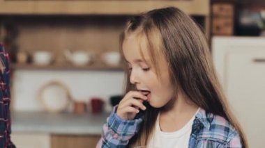 Anne ve kızı bir mutfak üzerine taze pişmiş çikolata Noel kurabiyeleri süt ile birlikte tat