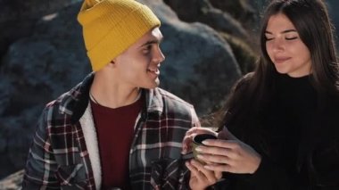 Termos dağ zemin üzerine birkaç aşk içecek çay üzerinden bir kupa. Taşlar üzerinde oturan ve güzel doğa üzerinde seyir turistler. Turizm, dinlenme, tatil, Doğa, zam kavramı