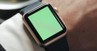 İş adamı elinde smartwatch yeşil ekran chroma anahtar ile kapatın. Güç üzerinde dokunma ve hareket kaydırma. Arka planda rahat kafe.