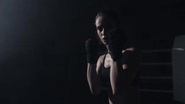 Kadın Boxer yumruk kamera tarafına-Boxer grev yakın. İzleyici video boks. Kadın rakibini çekici yapıyor. Yavaş hareket