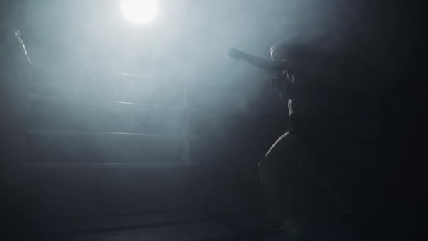 Female boxer training in the dark ring. Slow motion. Silhouette. Boxing concept — Stock Video
