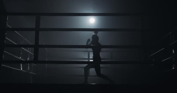 Boxeadora entrenando en el anillo oscuro. En cámara lenta. Silueta. Concepto de boxeo — Vídeos de Stock