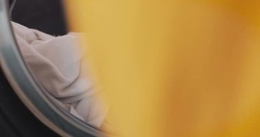 WOMANS eller çamaşır makinesine giysi yükleme. Self-Servis kamu Çamaşırhane.