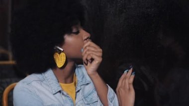 Depresif, üzgün younf afro-Amerikan kadın gece bir toplu taşıma sürme. Pencereden dışarı bakıyor..