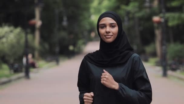 Młody preety Muslin kobieta ubrana w Hijabt w parku spotkanie Atrractive młody człowiek Running uśmiechnięta koncepcja zdrowy styl życia zbliżenie. — Wideo stockowe