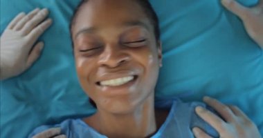 Genç, korkmuş kadın hastane sedyesinde yatarken ağlıyor. Afro-Amerikan hasta bir kızın ambulansla hastaneye nakledilişinin en iyi görüntüsü. Sağlık ve hastalık kavramı.