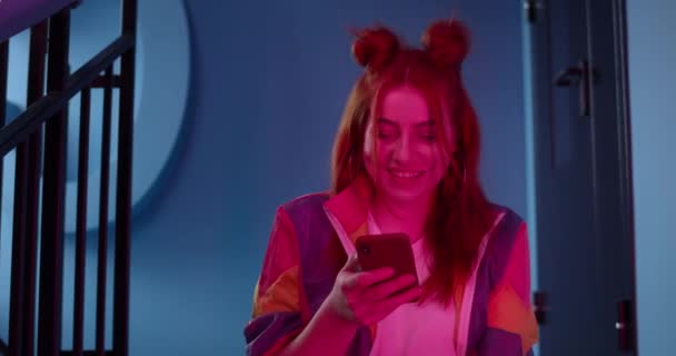 Crop view of millennial female person scrolling social media news feed and laughing. Young cheerful woman watching funny video while looking and touching smartphone screen. — Stock Video