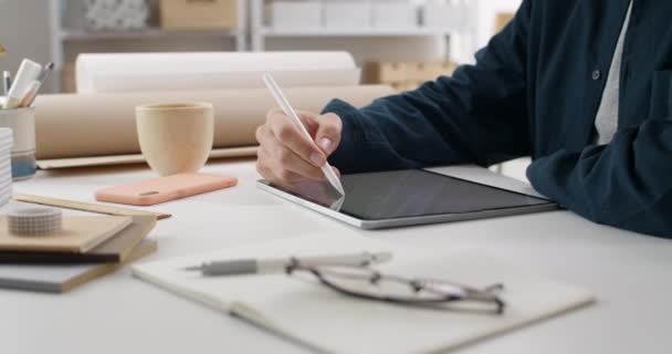 Vista de corte de mãos de designer gráfico usando estilete enquanto esboça no bloco de notas na mesa. Foco no processo de desenho digital. Conceito de arte moderna e tecnologia. — Vídeo de Stock