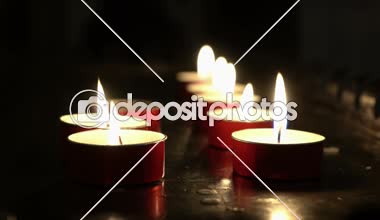 row of candles in a church