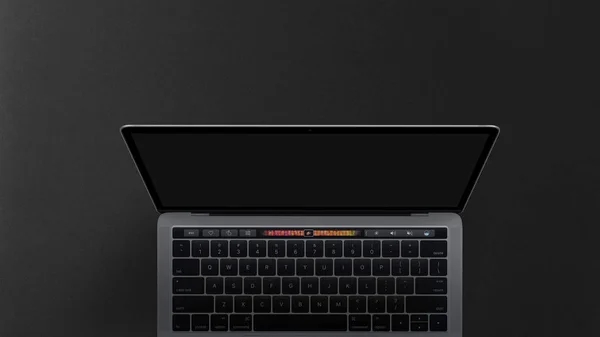 笔记本电脑与空白屏幕上的工作表黑暗背景 顶部视图图像 — 图库照片