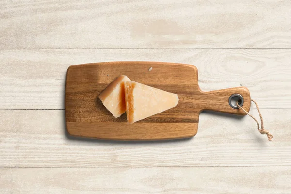 Serving board with cheese on table