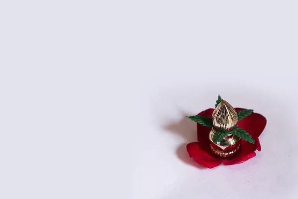 Copper Kalash with coconut and mango leaf with floral decoration on a white background. Essential in hindu puja. - Image