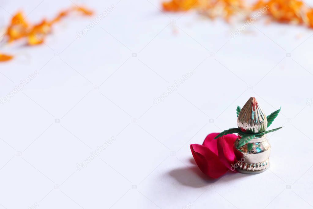 Copper Kalash with coconut and mango leaf with floral decoration on a white background. Essential in hindu puja. - Image