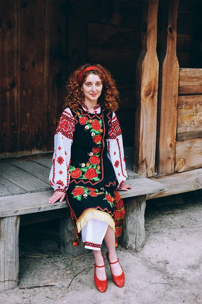 Young Slavonic Woman Traditional Embroidered Costume Red Shoes Sitting Porch — Stock Photo, Image