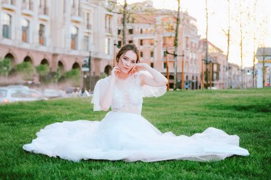 Yaz akşamları çimenlerin üzerine oturmuş beyaz elbiseli çekici genç gelin