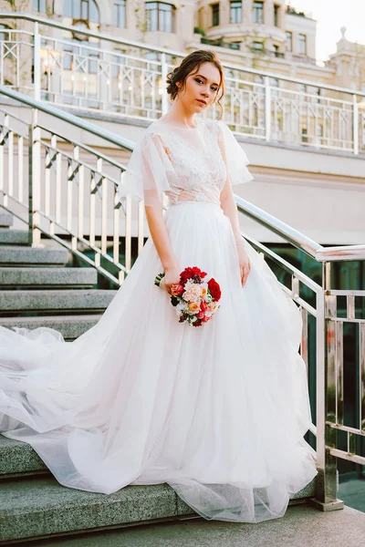 レースとチュール夕日で階段を踏んで作られたウェディング ドレスを流れる白の愛らしい白人花嫁 — ストック写真