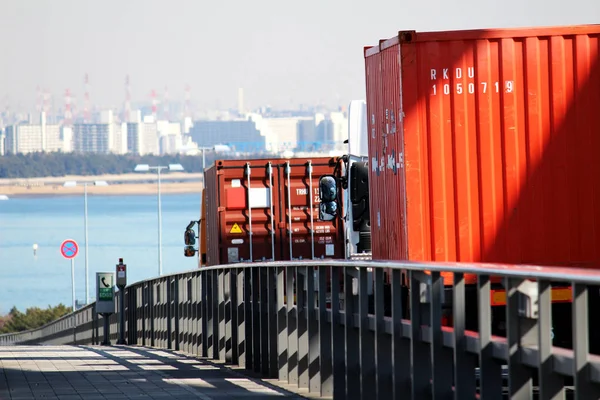 Container transportation truck across the bridge over the ocean