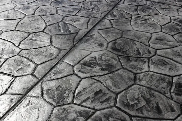 A cobblestone floor shining in the afternoon sunlight