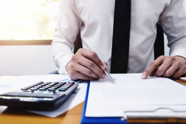 Businessman is using a pen for financial data analyzing counting