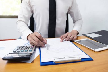 Businessman is using a pen for financial data analyzing counting