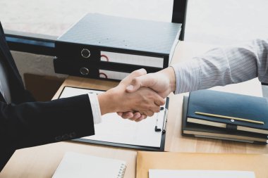 Businessmen making handshake in the office room