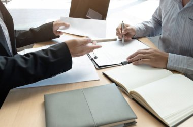 Boss sending a resignation letter to the employee on the table i