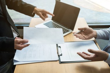 Boss sending a resignation letter to the employee on the table i