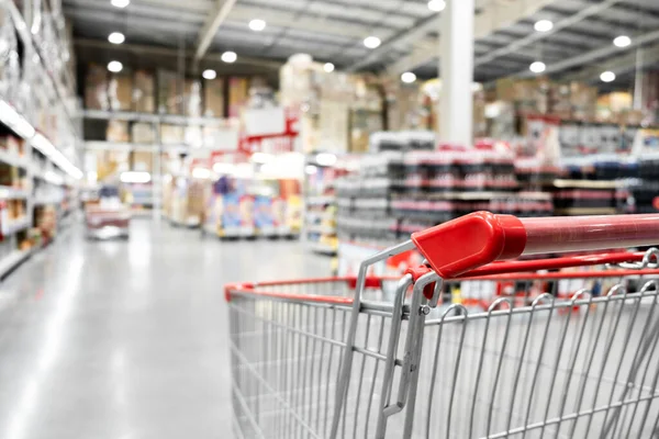 The empty red shopping cart in supermarket with blurred background, Shopping concept.