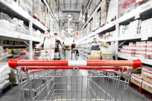 The empty red shopping cart in supermarket with blurred background, Shopping concept.