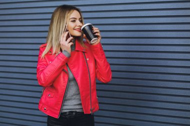 Genç güzel kız içecekler kahve ve telefonda konuşurken