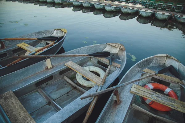 Boat station. Old boats on the water at the pier