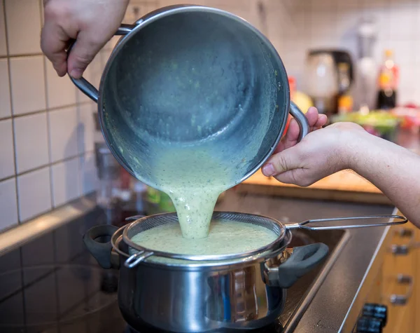 Man cooking Zucchini soup with gorgonzola