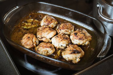 Fırında tavuk bacak biftek üzerinde beyaz şarap soslu ve soğan yemek pişirme cam