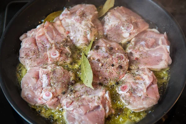 Tavuk bacağı biftek üzerinde beyaz şarap soslu otlar baharat ve tavada ızgara soğan ile