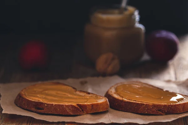 花生酱烤面包配2片黑麦面包 健康食品组成在质朴的木桌顶部背景 — 图库照片
