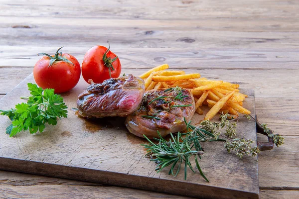 Grilled Turkey Ossobuco Cutting Board French Fries Tomatoes — Stock Photo, Image