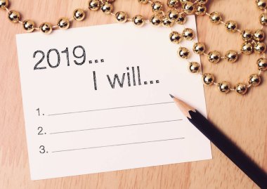 2019 goals list with gold decoration. We wish you a new year filled with wonder, peace, and meaning. clipart