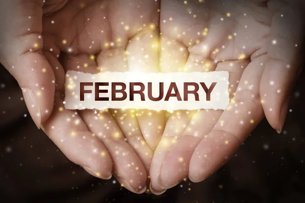 Hand showing february. May this month have a successful start and a lot of great achievements in the end!