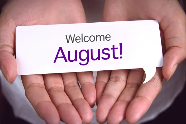 Hand showing welcome august.