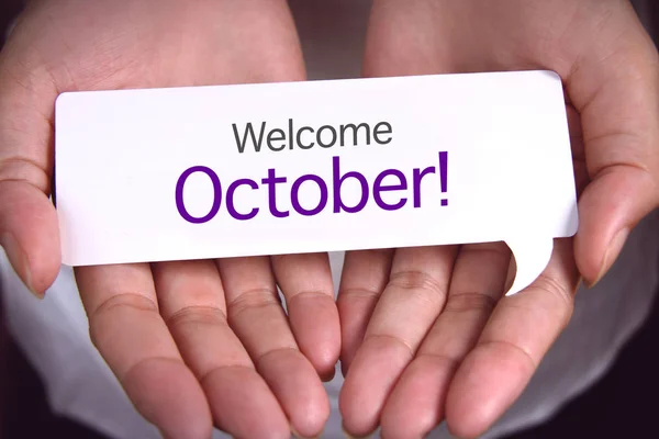Hand showing welcome october.