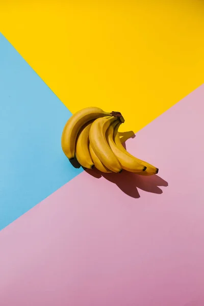 Yellow banana on blue and pink and yellow background