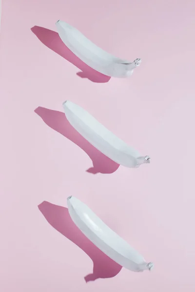 White banana on pink background
