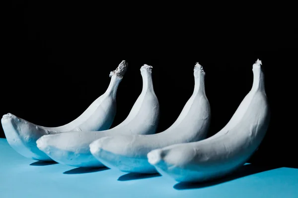 White banana on black and blue background